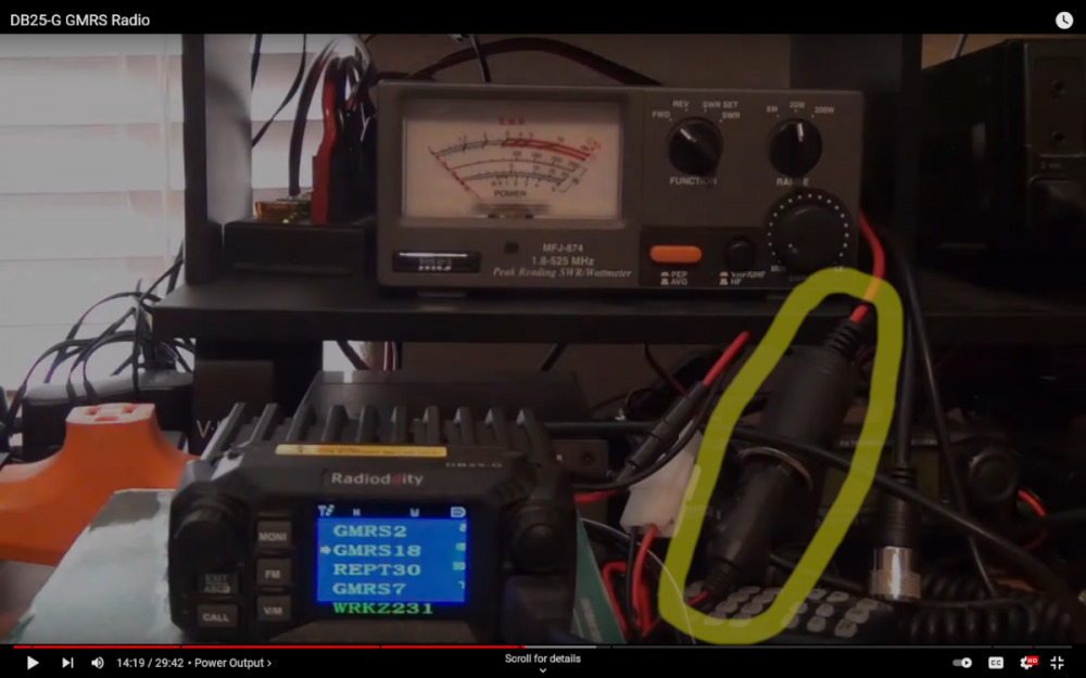 A screenshot from Gadget Talk's YouTube video reviewing the Radioddity DB25-G, with the connected cigarette lighter plug highlighted by me.